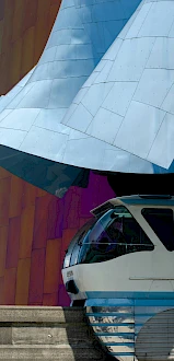 The Seattle Monorail completing its journey from Westlake Center and passing in front of MoPOP as it arrives at Seattle Center.