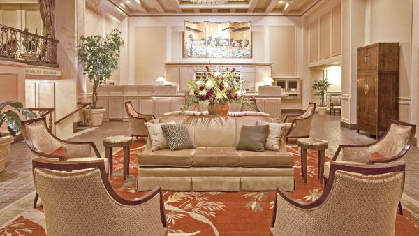 The lobby at Mayflower Park Hotel comfortable seating, chandelier, and fresh flowers and