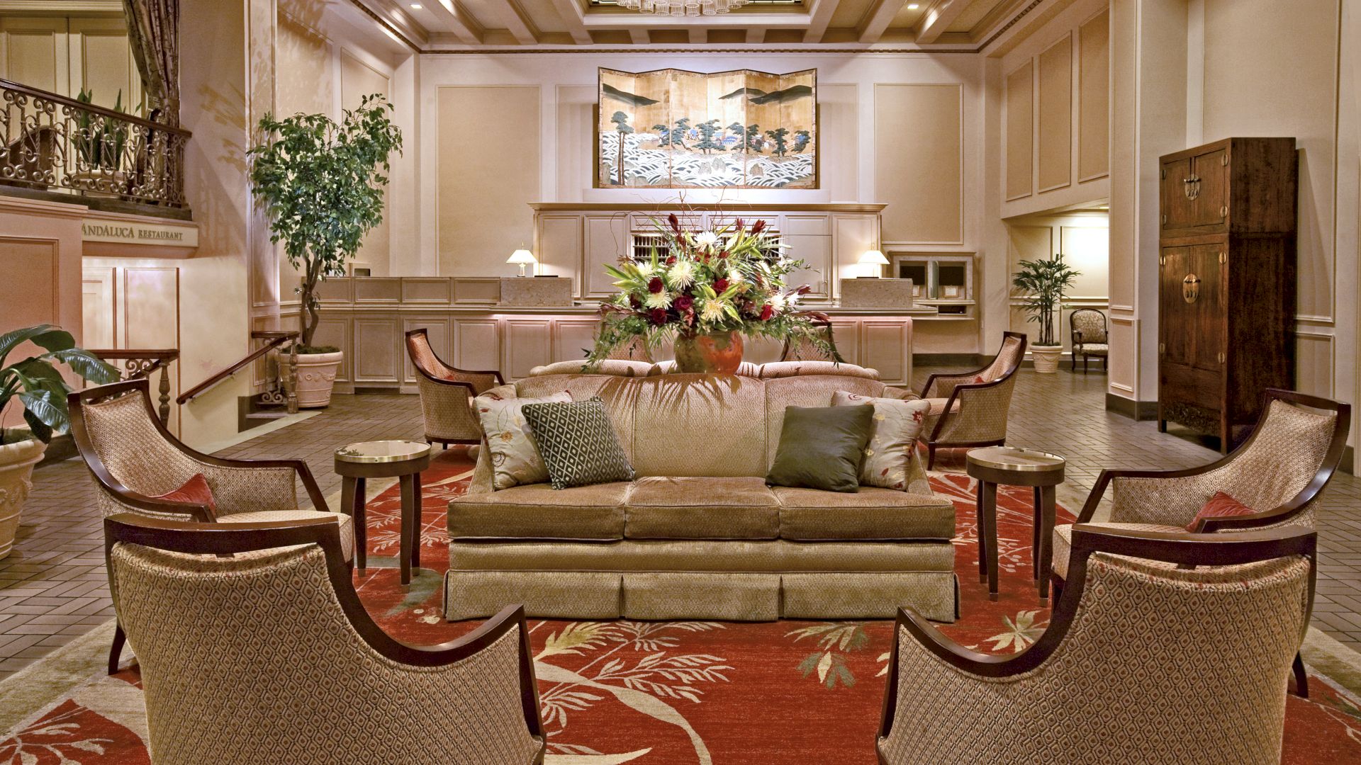 A luxurious hotel lobby with a seating area, chandeliers, plants, and a reception desk in the background. Top it at 140 characters, always ending the sentence.