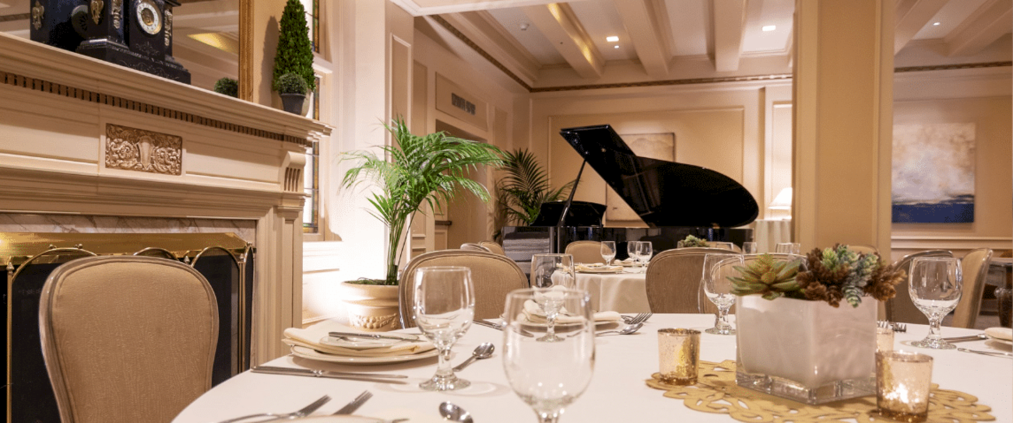 A classy dining room with a grand piano, elegant table settings, and a cozy, upscale ambiance.
