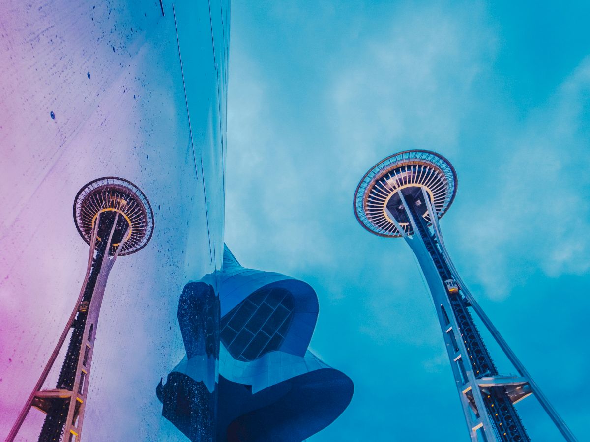 A vibrant view of the Space Needle reflected in MoPOP's glossy surface, just a short Monorail ride from our downtown Seattle hotel at Seattle Center.